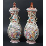 PAIR OF CHINESE EXPORT VASES AND COVERS, 19th century, of flattened ovoid form, enamelled with