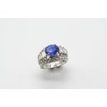 A SAPPHIRE AND DIAMOND RING the oval-shaped sapphire weighs 3.14 carats and is set within a surround