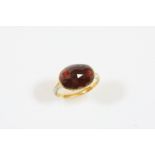 A GEORGIAN GARNET AND ENAMEL RING the oval shaped faceted foil backed garnet is set in a gold