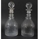 A MATCHED PAIR OF GEORGIAN GLASS DECANTERS AND STOPPERS, of mallet form with three ring necks