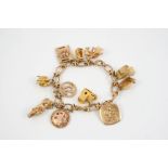 A 9CT. GOLD OVAL LINK BRACELET suspending assorted 9ct. gold charms, total weight 54 grams.