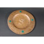 ARTS & CRAFTS COPPER TRAY a hand beaten circular tray, inset with Ruskin style roundels and with