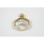 A CRYSTAL THREE SIDED SPINNING FOB SEAL engraved on two sides with a coat of arms, in an ornate