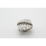A DIAMOND AND 18CT. WHITE GOLD RING the gold band is ridged to one side and mounted with a row of