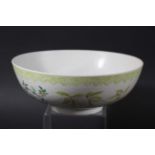 CHINESE BOWL, Yongzheng, enamelled with flowering prunus and other foliage beneath a light green