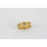 A LADY'S 18CT. GOLD WEDDING BAND BY GERALD BENNEY with engraved swirl decoration, maker's mark for