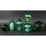 COLLECTION OF SIX GREEN GLASS DUMPS OR ORNAMENTS, to include a blue and yellow flower in a pot,