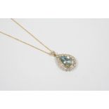 AN AQUAMARINE AND DIAMOND CLUSTER PENDANT the pear-shaped aquamarine is set within a surround of