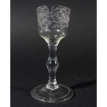 WINE GLASS, circa 1760, the ogee bowl with floral engraving, the balustroid stem with a central knop