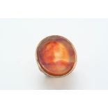 A CARNELIAN CARVED INTAGLIO RING depicting the head and shoulders of a mythological figure, in