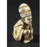 JAPANESE NETSUKE, Meiji, carved as a priest kneeling down wearing a tall hat, height 4.5cm