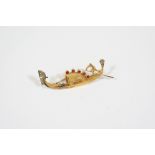 AN 18CT. GOLD GONDOLIER BROOCH mounted with a circular-cut diamond and five circular-cut rubies,