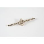 AN EARLY 20TH CENTURY DIAMOND BROOCH the quatrefoil design is mounted with four old-cut diamonds,