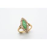 A JADE AND PEARL SET CLUSTER RING the marquise-shaped jade is set within a surround of half