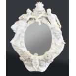 MEISSEN STYLE PORCELAIN MIRROR, 19th century, the oval plate inside a frame centred on a bust of