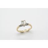 A DIAMOND SOLITAIRE RING the pear-shaped diamond is set with a tapered baguette-cut diamond to