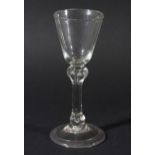 WINE GLASS, circa 1760, the rounded funnel bowl above a balustroid stem with shoulder and basal