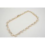 A MOONSTONE NECKLACE formed with graduated oval-shaped moonstones, collet set in gold, 43cm. long.