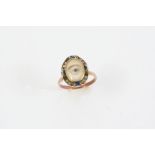 A VICTORIAN MINIATURE EYE RING the painted eye set within a suround of rose-cut diamonds and blue