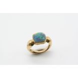 A BLACK OPAL SINGLE STONE RING the cushion-shaped solid black opal is mounted in an ornate