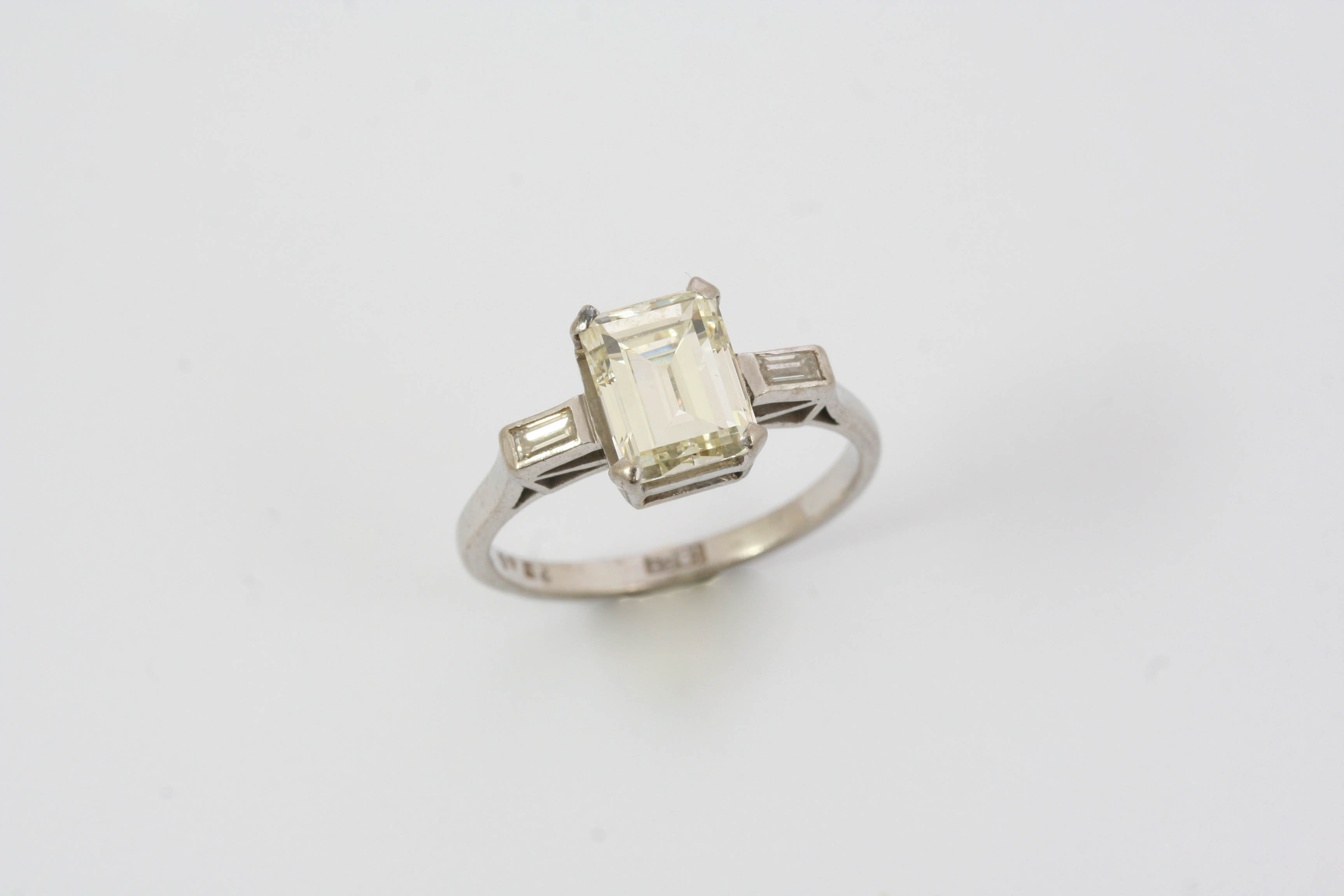 A DIAMOND SOLITAIRE RING the emerald-cut diamond weighs approximately 1.80 carats and is set with