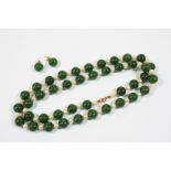 A JADE AND CULTURED PEARL NECKLACE formed alternately with green jade beads and cultured pearls,