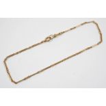 A 9CT. GOLD WATCH CHAIN formed with long and short links, stamped with maker's initials J.C. & S. to