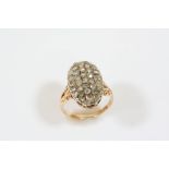 A DIAMOND CLUSTER RING the oval-shaped ring is set with rose-cut diamonds, in 15ct. gold. Size O.