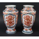 PAIR OF JAPANESE IMARI VASES, late 19th century, of baluster form with panels of dragons, height