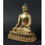 SINO-TIBETAN GILT BRONZE BUDDHA. probably 19th century, seated holding a vase, on a lotus base,