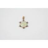 AN OPAL AND DIAMOND PENDANT the circular solid white opal is set within a gold surround mounted with