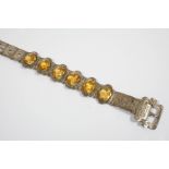 A CITRINE AND SILVER BRACELET the foliate engraved belt design is mounted with six oval-shaped