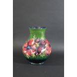 MOORCROFT VASE - ANEMONE a large vase painted in the Anemone design on a green ground. Marked,