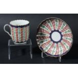 WORCESTER FLUTED COFFEE CUP AND SAUCER, circa 1760, over glaze painted with a trellis pattern in