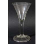 LARGE WINE GLASS, circa 1760, the drawn trumpet bowl above a plain stem with tear on a dome foot