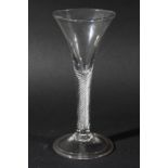 GEORGIAN WINE GLASS, the trumpet shaped bowl above a multiple spiral air twist stem and folded foot,