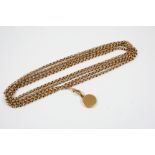 A VICTORIAN 9CT. GOLD LONG GUARD CHAIN formed with circular hammered links, suspending a circular