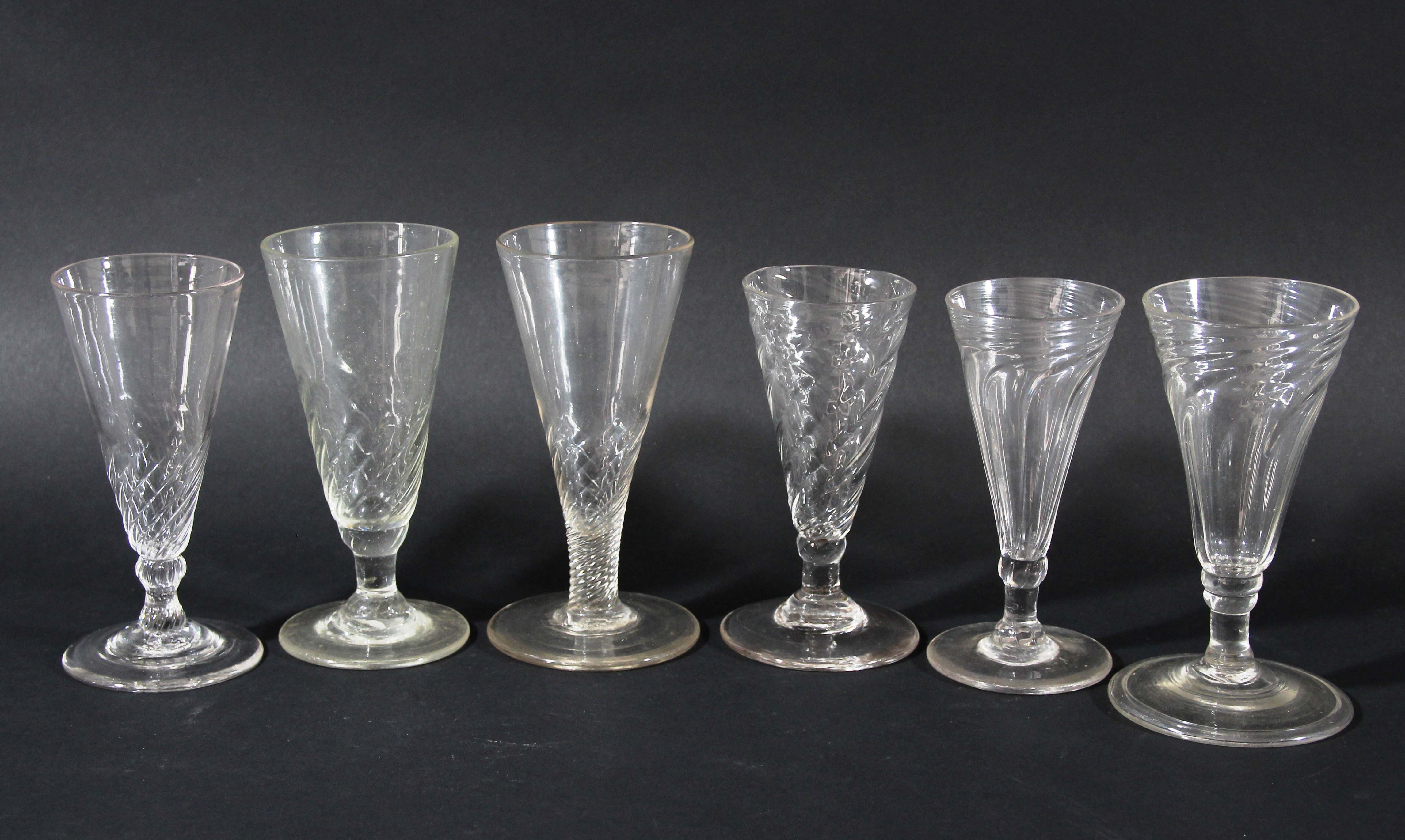 GROUP OF SIX GLASSES, late 18th century, the drawn trumpet bowls with wrythen twist, heights 12-13cm