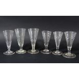 GROUP OF SIX GLASSES, late 18th century, the drawn trumpet bowls with wrythen twist, heights 12-13cm