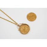 A GOLD HALF SOVEREIGN 1911, in a 9ct. gold mount and on a fine link chain, total weight 8.0 grams,