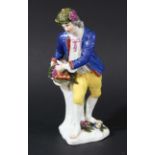 MEISSEN FIGURE OF A FRUIT SELLER, circa 1743, after Kaendler, standing holding a basket of grapes,