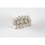 A DIAMOND THREE ROW RING formed with three rows of graduated brilliant-cut diamonds, in 14ct.