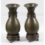 PAIR OF BRONZE AND YELLOW METAL INLAID VASES, late 19th century, of baluster form decorated with