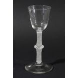 WINE GLASS, circa 1760, the rounded bowl on a multiple spiral opaque twist stem with a central knop,