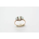 AN OPAL AND DIAMOND RING the three slightly graduated oval-shaped solid white opals are set with