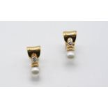 A PAIR OF DIAMOND AND CULTURED PEARL EARRINGS each 18ct. gold mount is set with a circular-cut