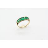 AN EARLY 20TH CENTURY EMERALD AND DIAMOND RING the five graduated rectangular-shaped emeralds are