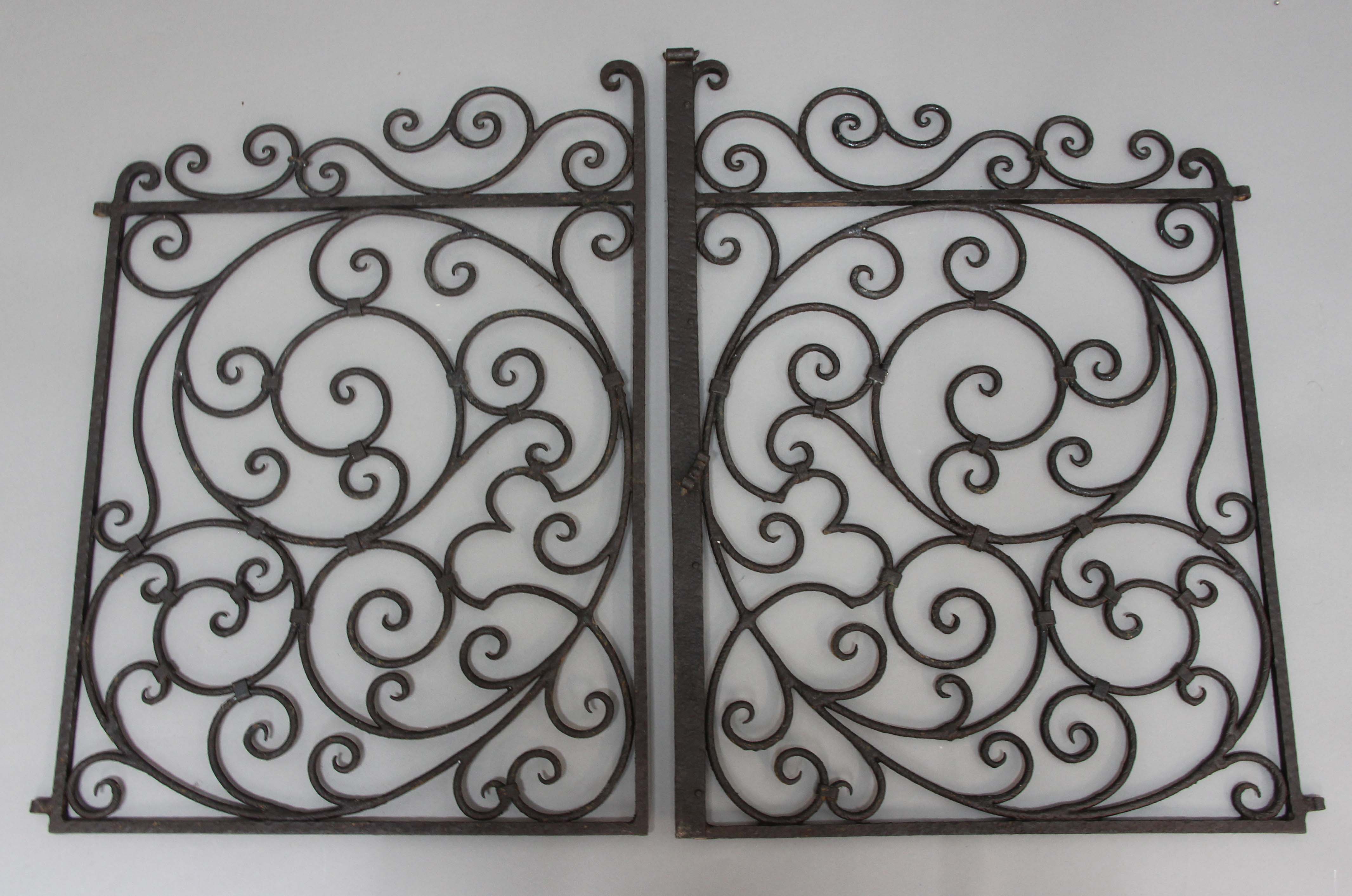 PAIR OF WROUGHT IRON GATES, with scrolling decoration, height 70cm, overall width 100cm