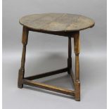 18TH CENTURY OAK CRICKET TABLE, the circular top raised on block and turned supports, height 64cm,