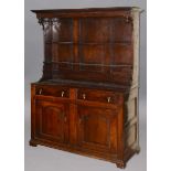 OAK DRESSER, mid 18th century, the two shelf rack with an overhang on a base with two fielded